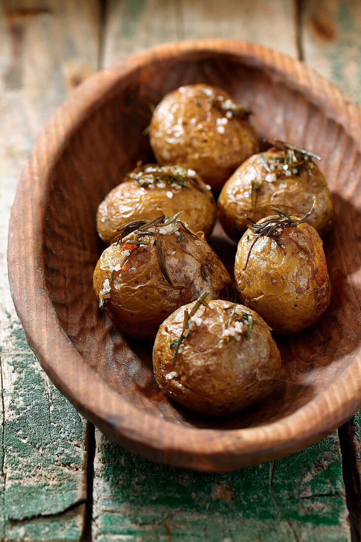 Baked potatoes in a wooden bowl