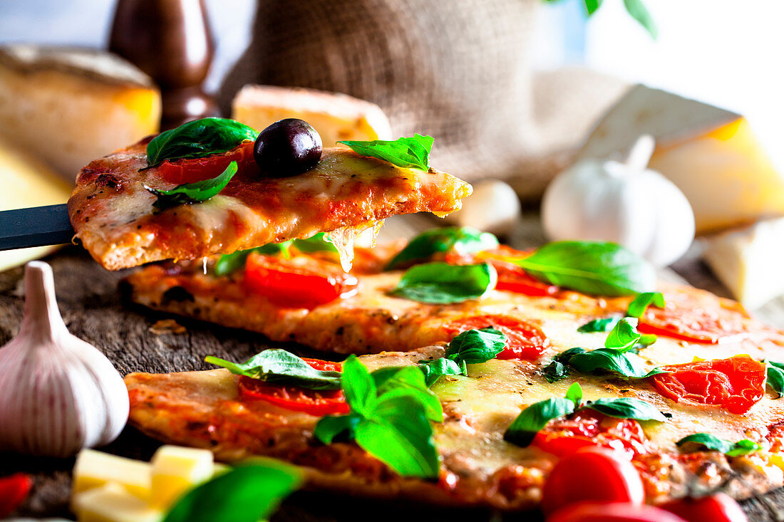 Rustic italian pizza with cheese, tomatoes and basil