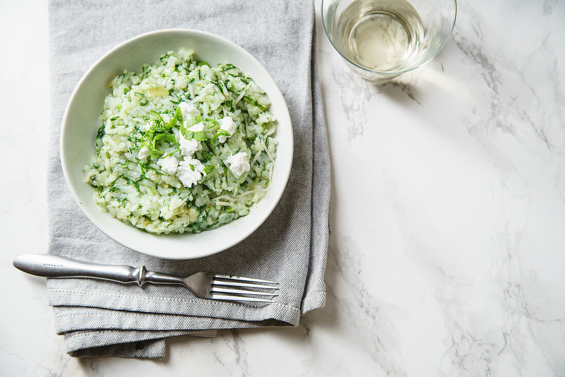 Spinach risotto with a glass of white wine