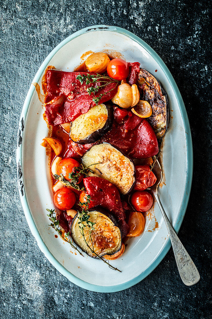 Pepper and aubergine medley with tomatoes on a serving platter