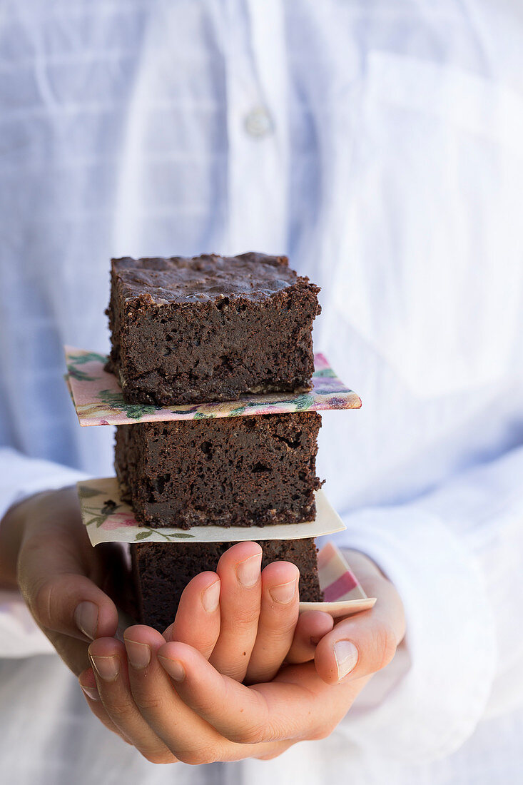 Girl Holding Stack of Chocolate Brownie