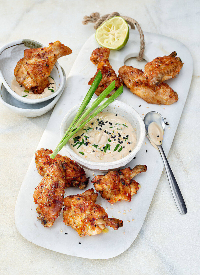 Chicken wings with a soya poke mayonnaise on a white marble board