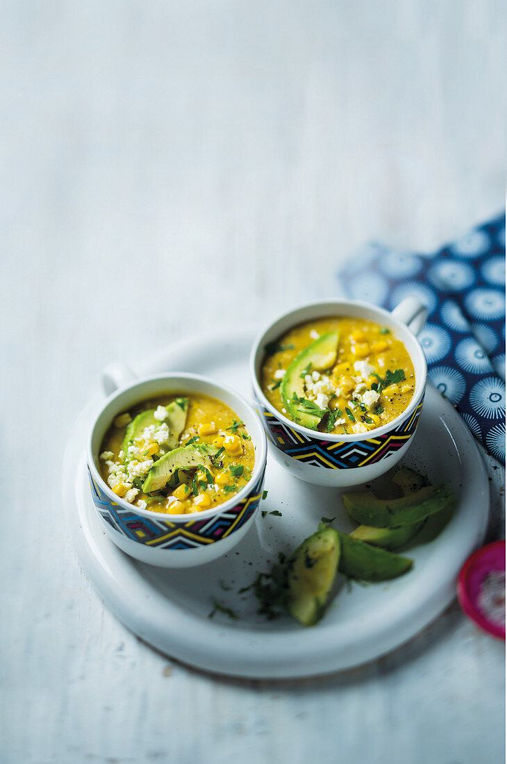 Potato and cheese soup with corn and avocado