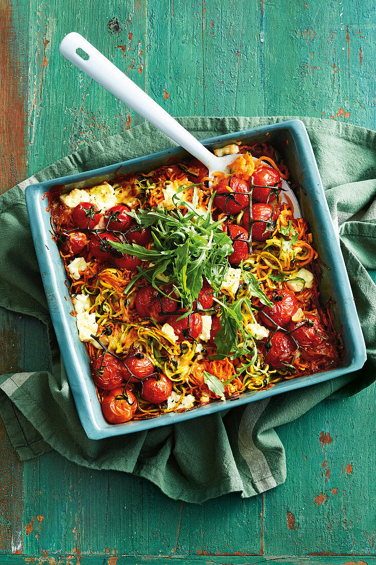 Zucchini noodle and sweet potato casserole with cherry tomatoes