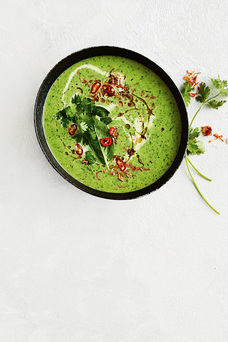 Vegan green coconut soup with peas and spinach