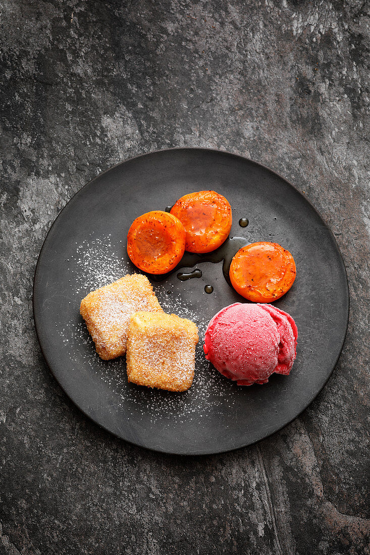 Leche frita with apricots and raspberry ice cream