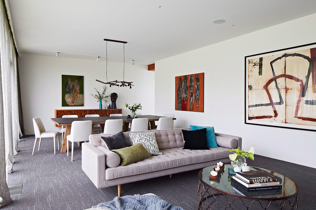 Modern living room with dining table behind the sofa