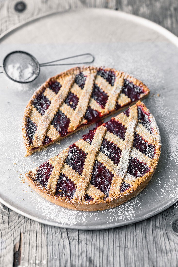 A small Linzer tart with currant jam