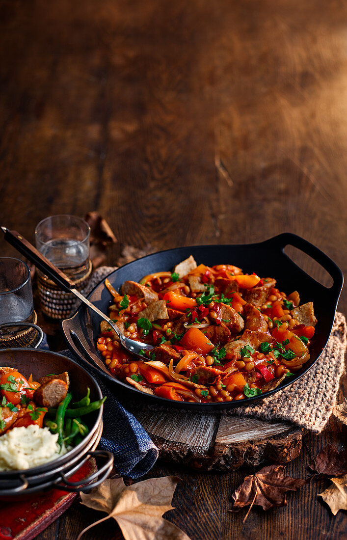 Autumnal campfire stew with beans and sausage