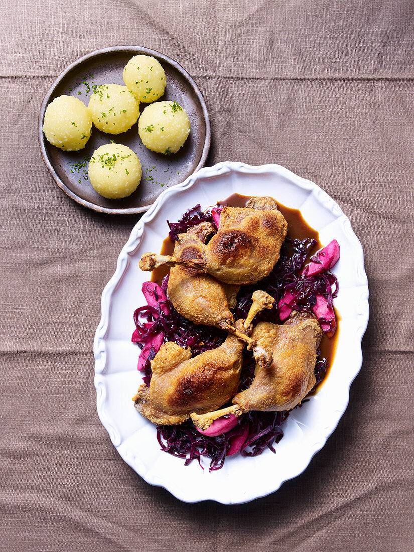 Confit duck legs on red cabbage with potato dumplings