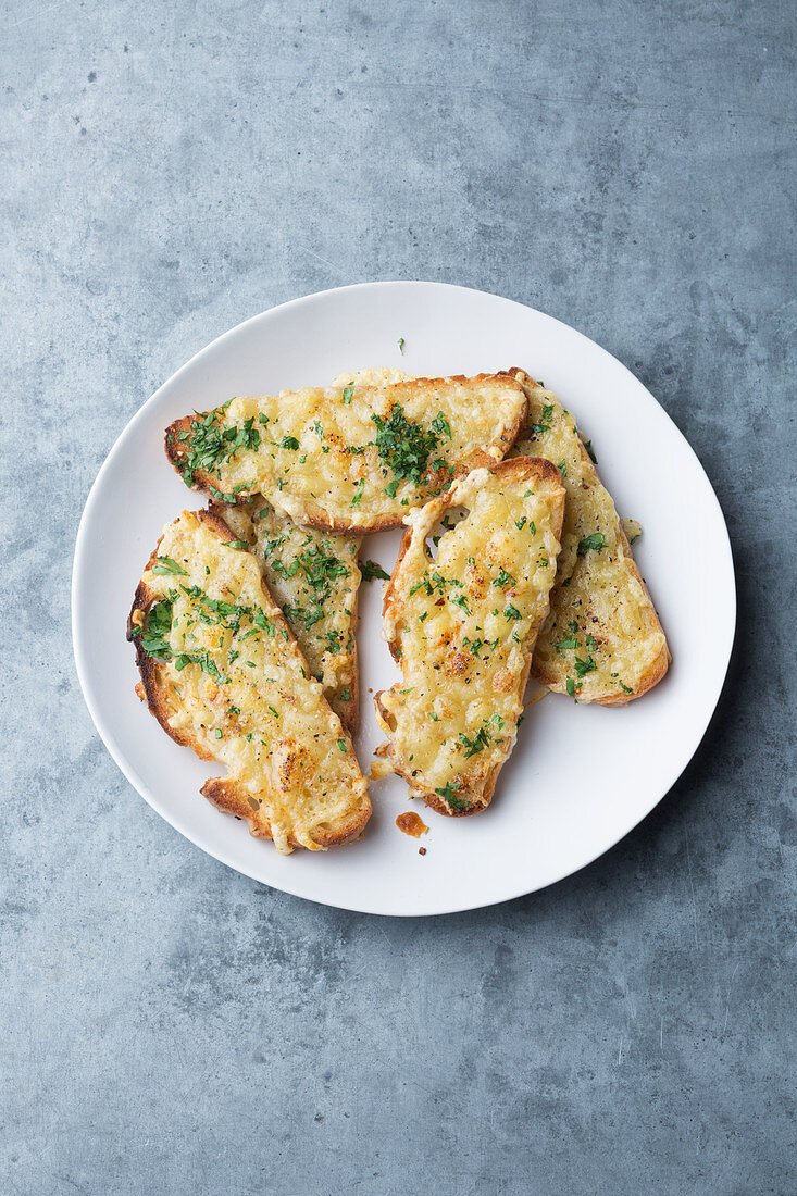 Grilled bread with herb butter and cheese