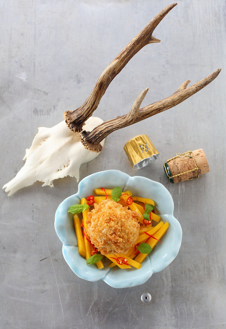 Pumpkin dumpling on a mango and chilli salad