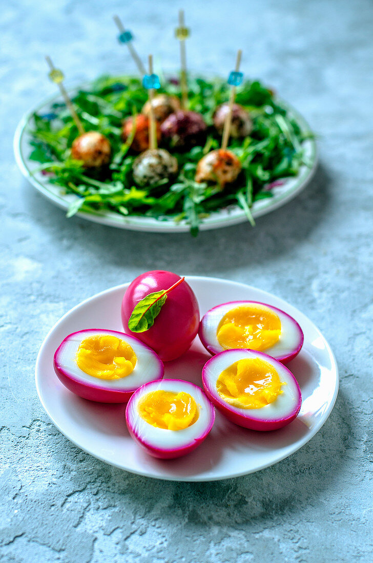 Chicken eggs, painted beet juice, quail eggs in a variety of spices and arugula