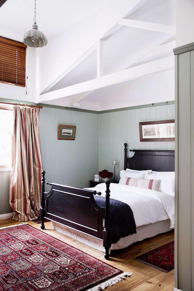 Bedroom with wooden bed in a converted barn