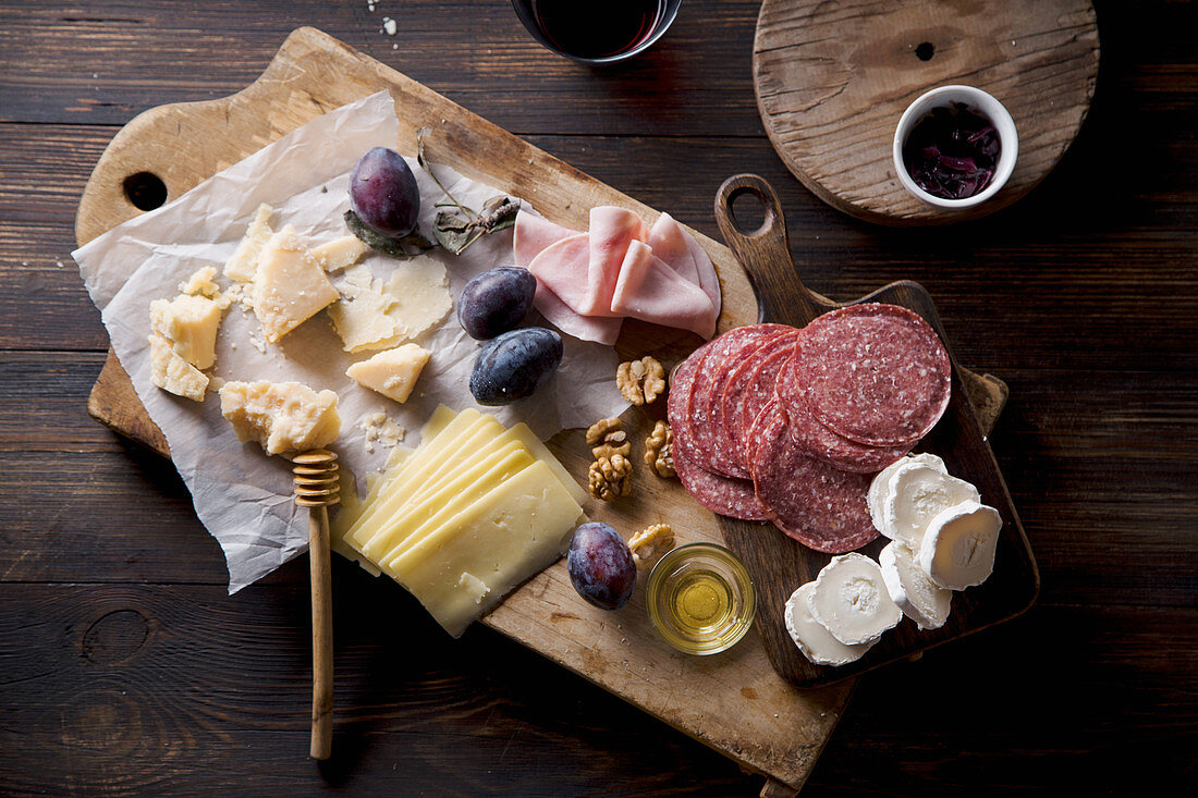 Käse- und Wurstplatte mit Honig, Nüssen und Zwetschgen zum Wein