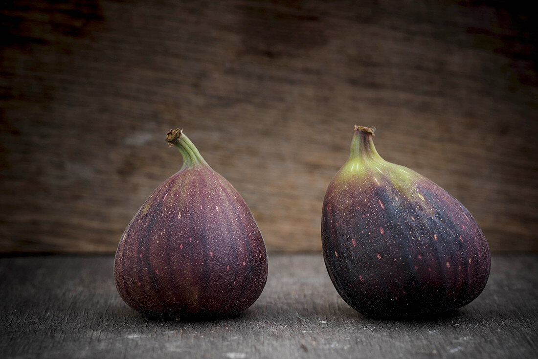 Two Figs on Wooden Background