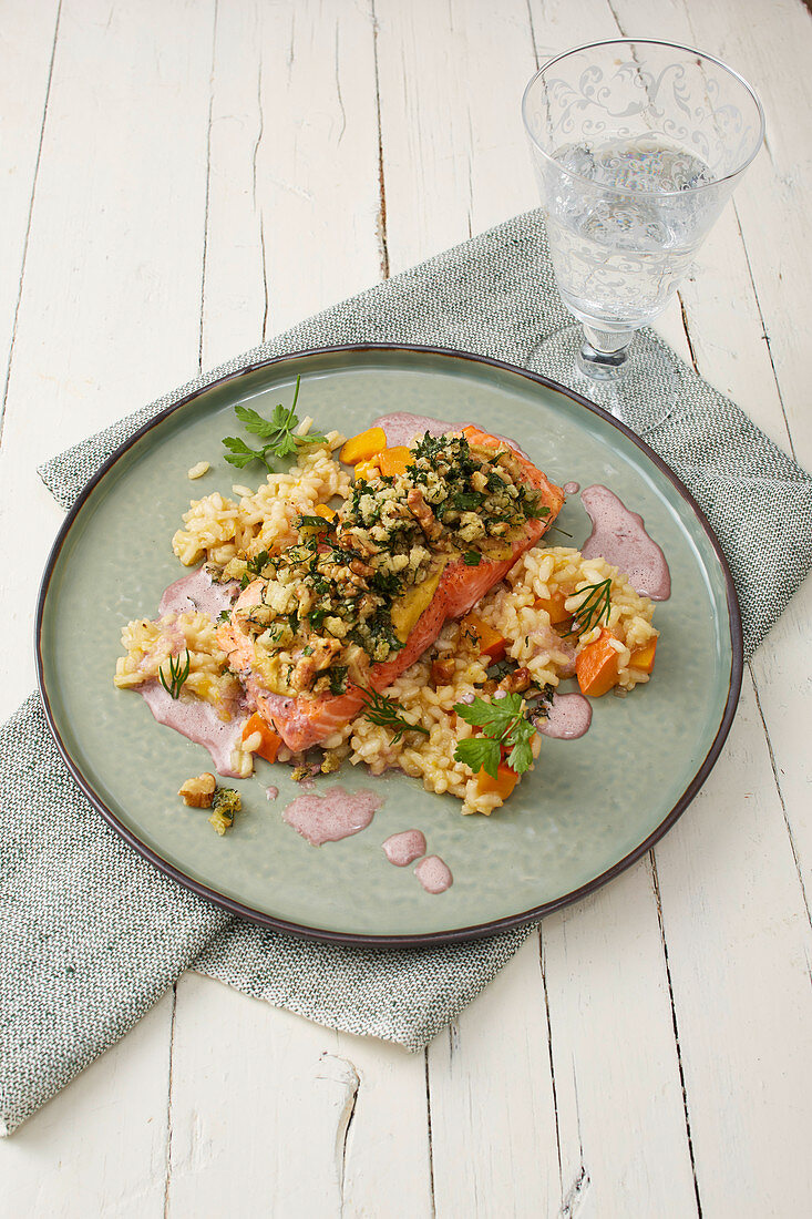 Salmon with a walnut crust on a bed of risotto with a red butter sauce