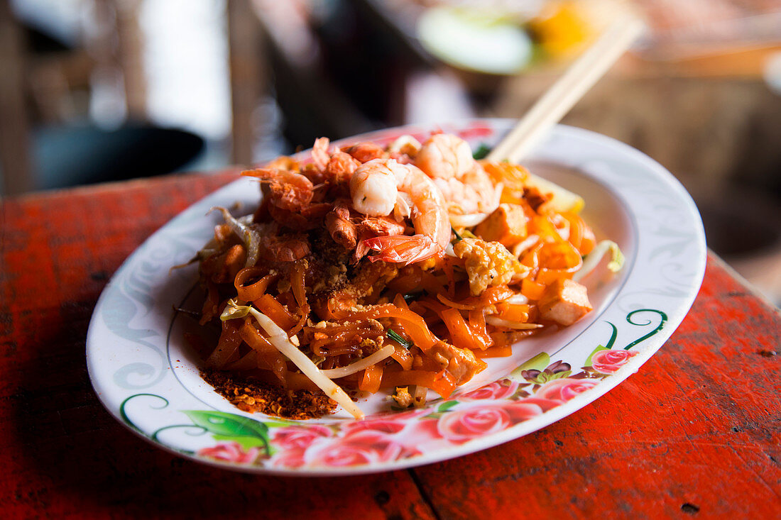 Traditional Pad Thai dish, served in a street food stand in Tha Kha Floating Market, Samunt Songkhram Province in Thailand