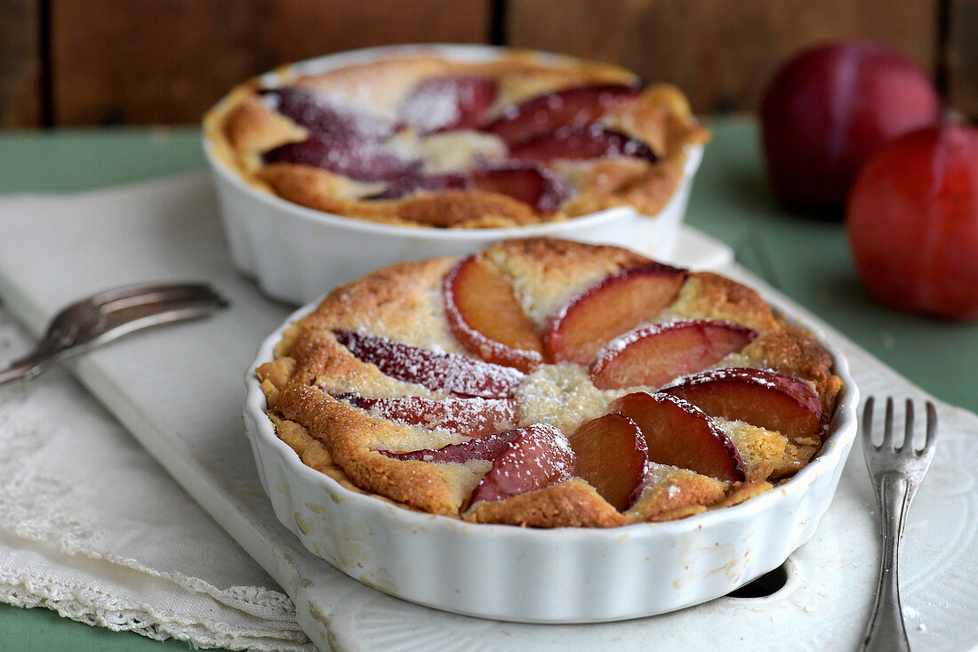 Baking of plum pie with almond frangipane, plumpie icing sugar