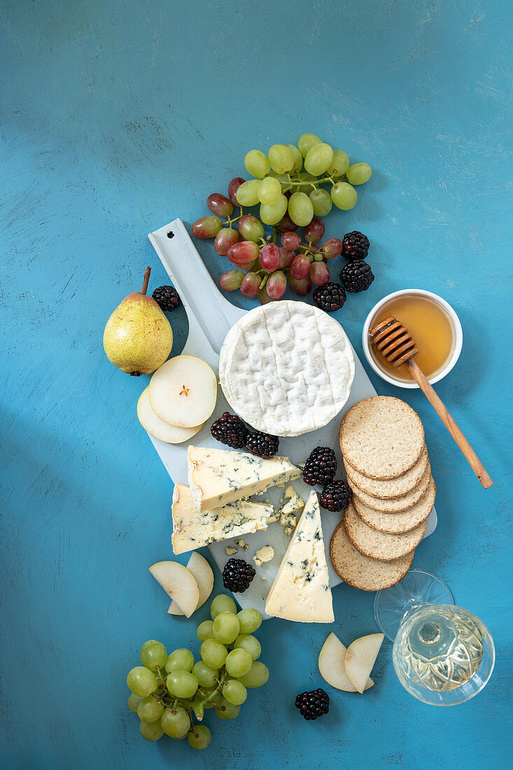 Cheese board with crackers and hones
