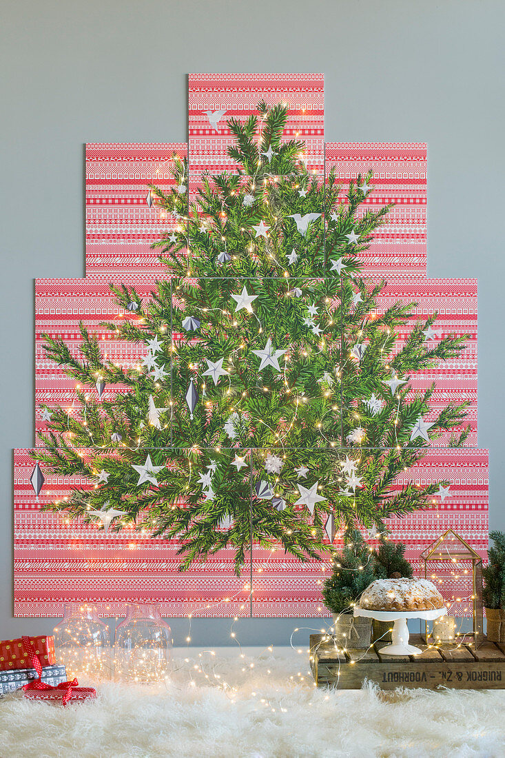 Picture of Christmas tree on red-and-white patterned panels on wall