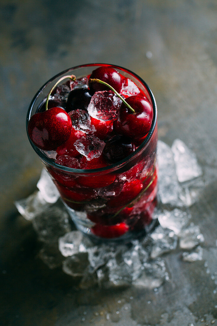 Cherries and ice cubes in a glass