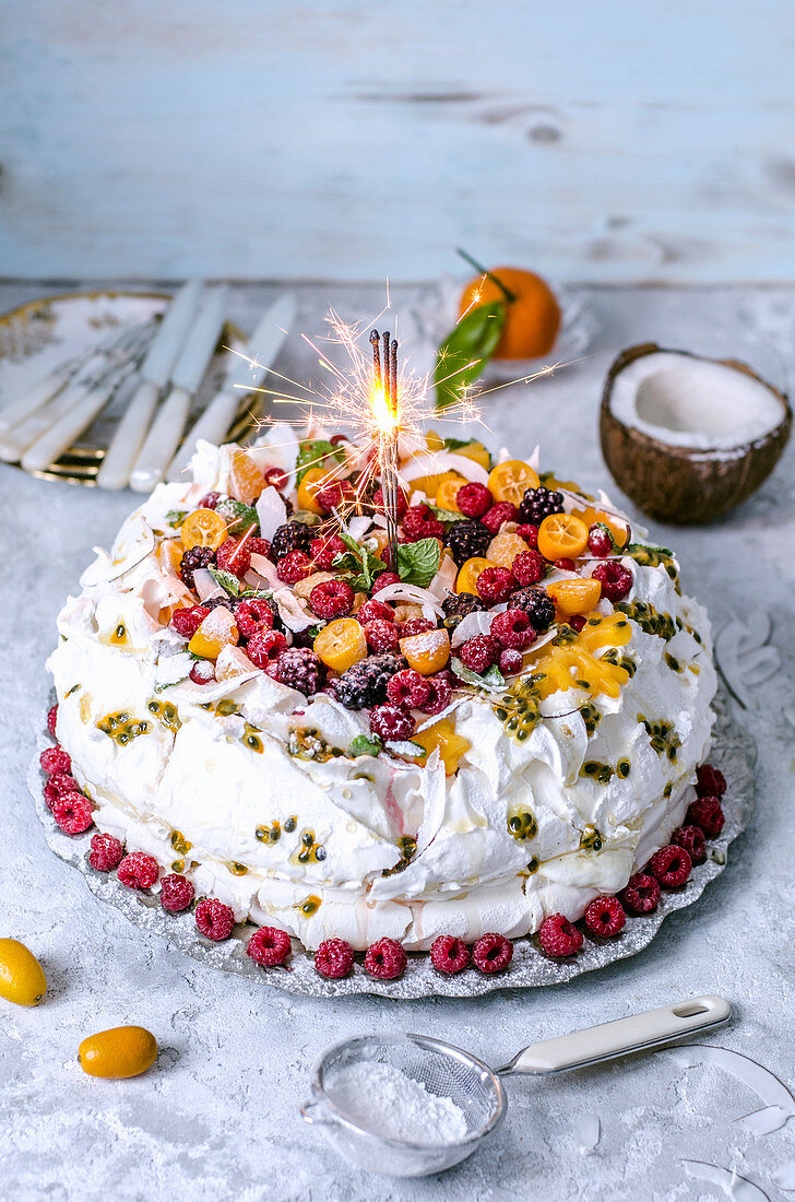 Pavlova cake with frozen berries and coconut