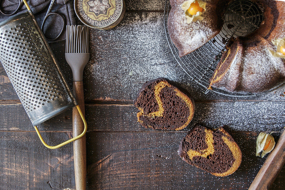 A chocolate and pumpkin wreath cake garnished with physalis (seen from above)