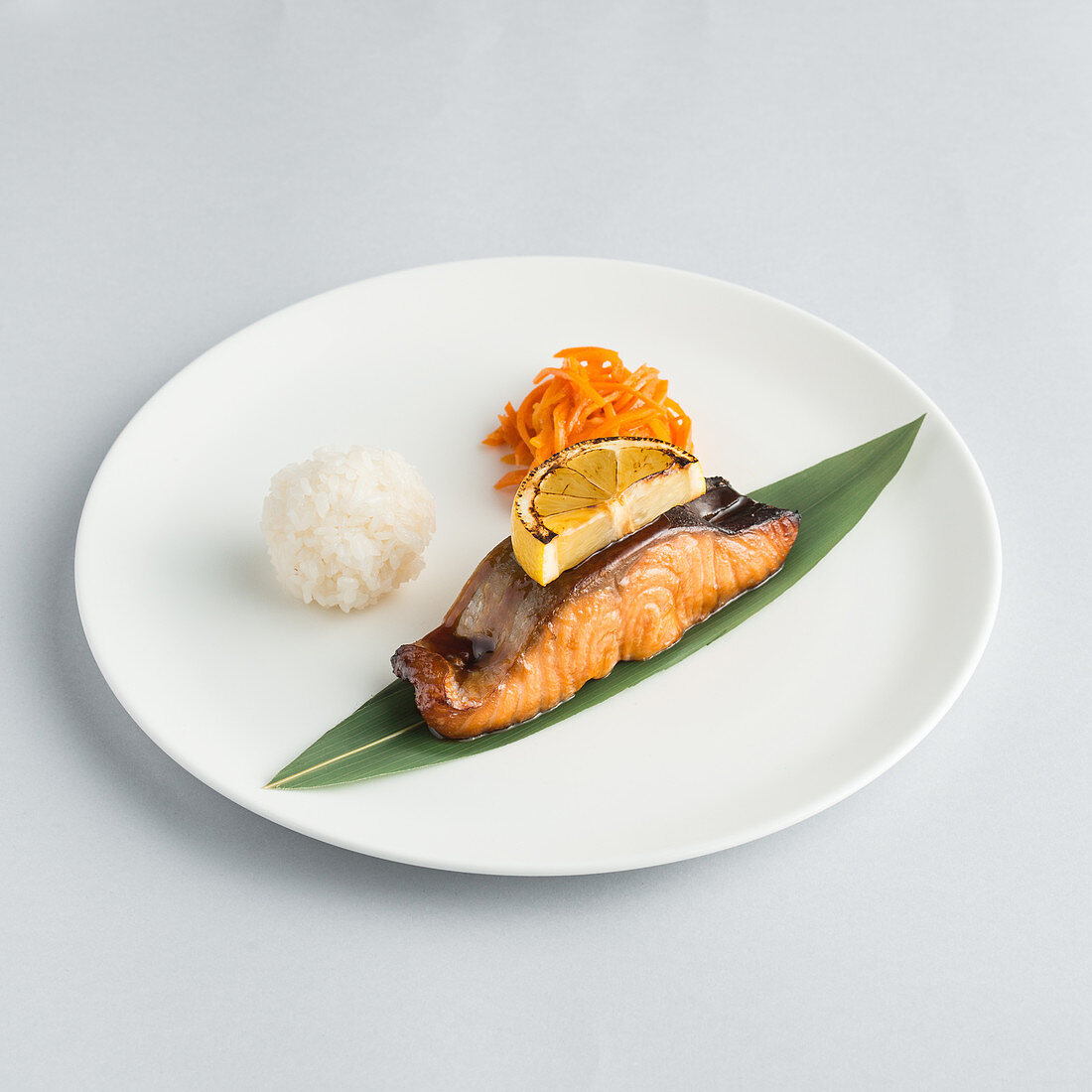 Salmon served with rice and grated carrot on a plate (Japan)