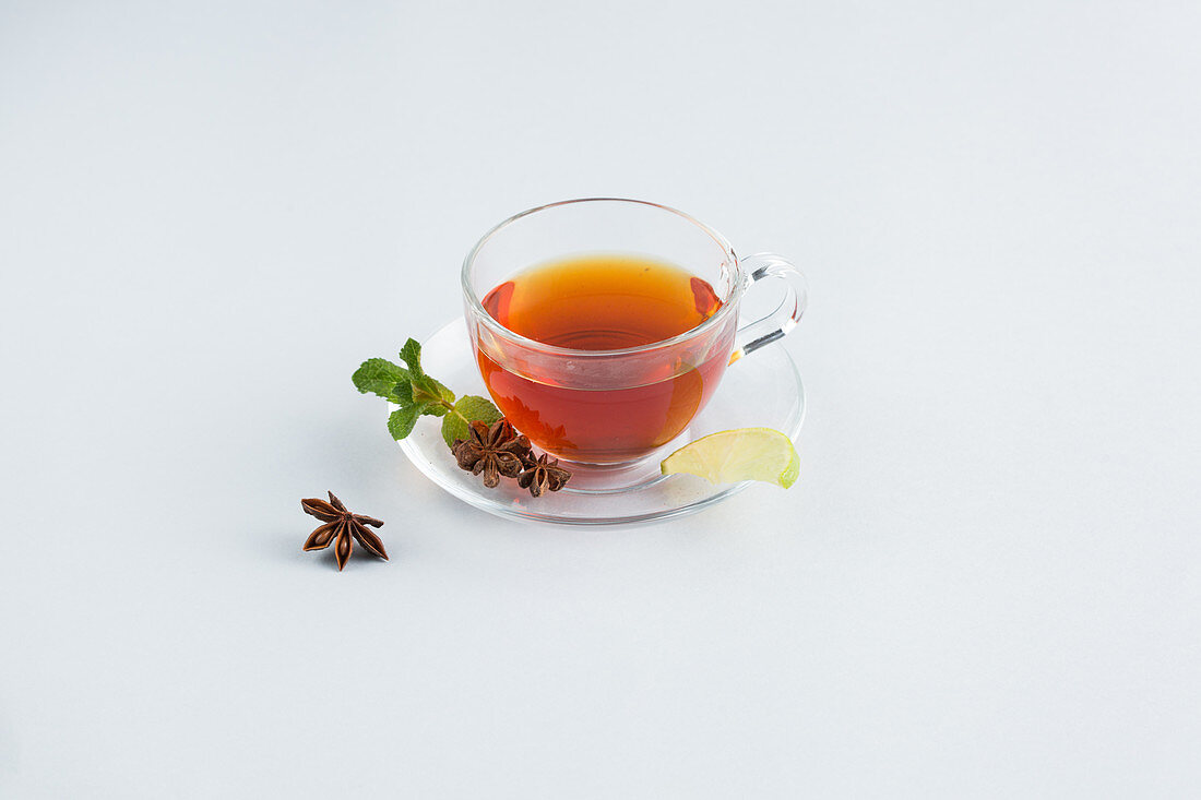Tea in a glass cup against a white background