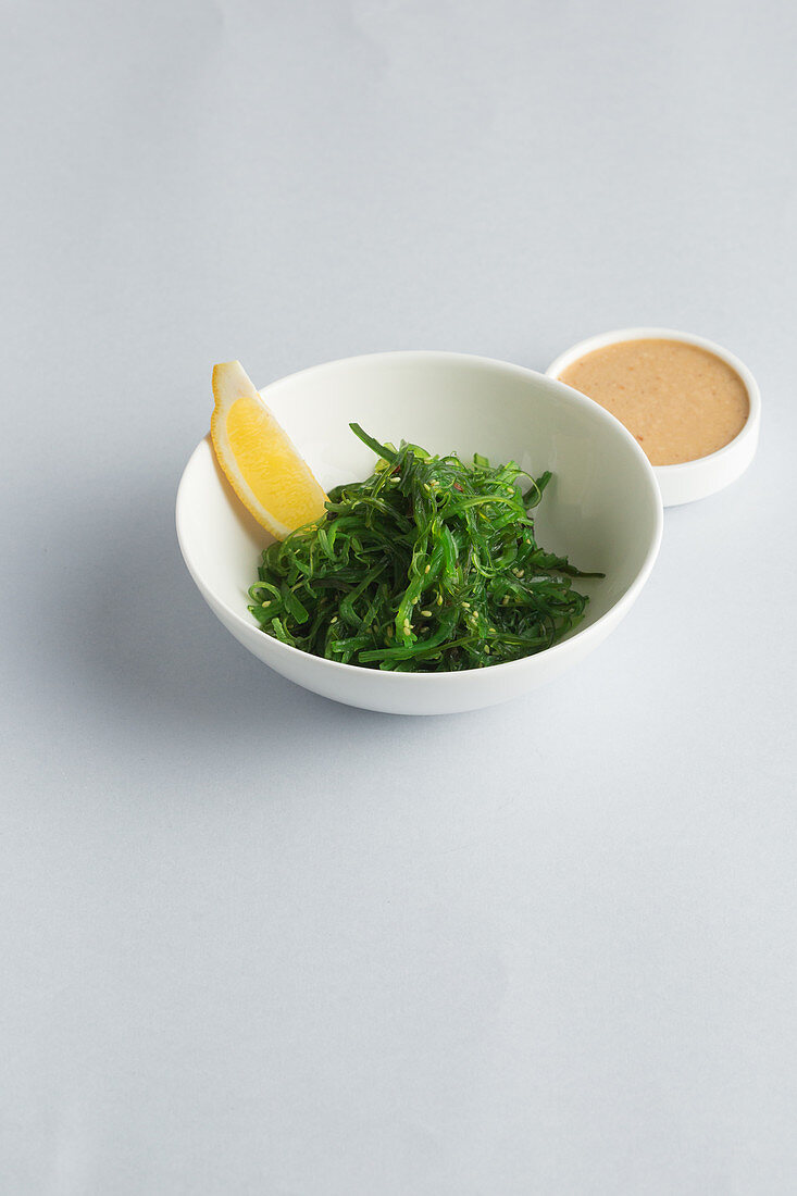 Algae salad in a bowl against a white surface (Japan)