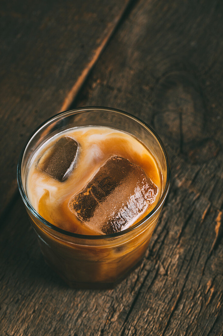 A glass of ice cold coffee in milk