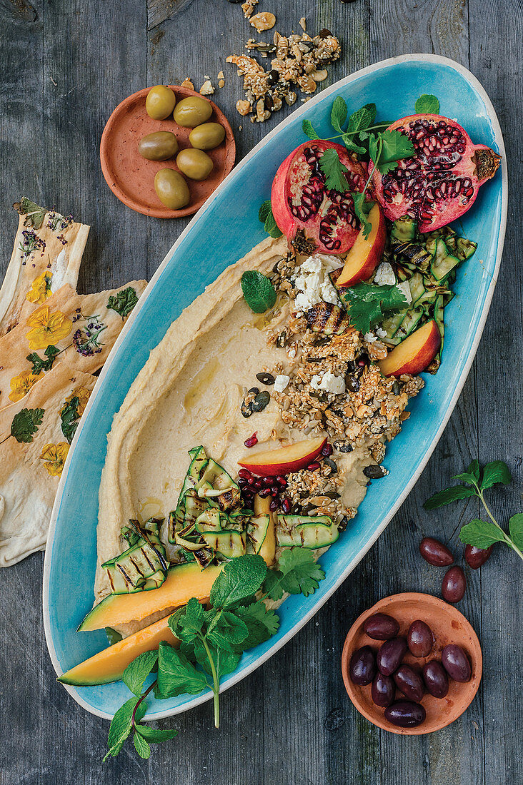 Peanut butter hummus with sesame seeds, vegetables and fruits