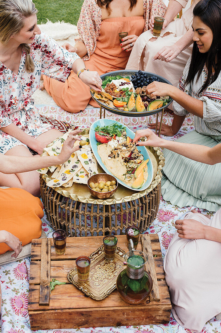 Friends at a celebration with Moroccan dishes