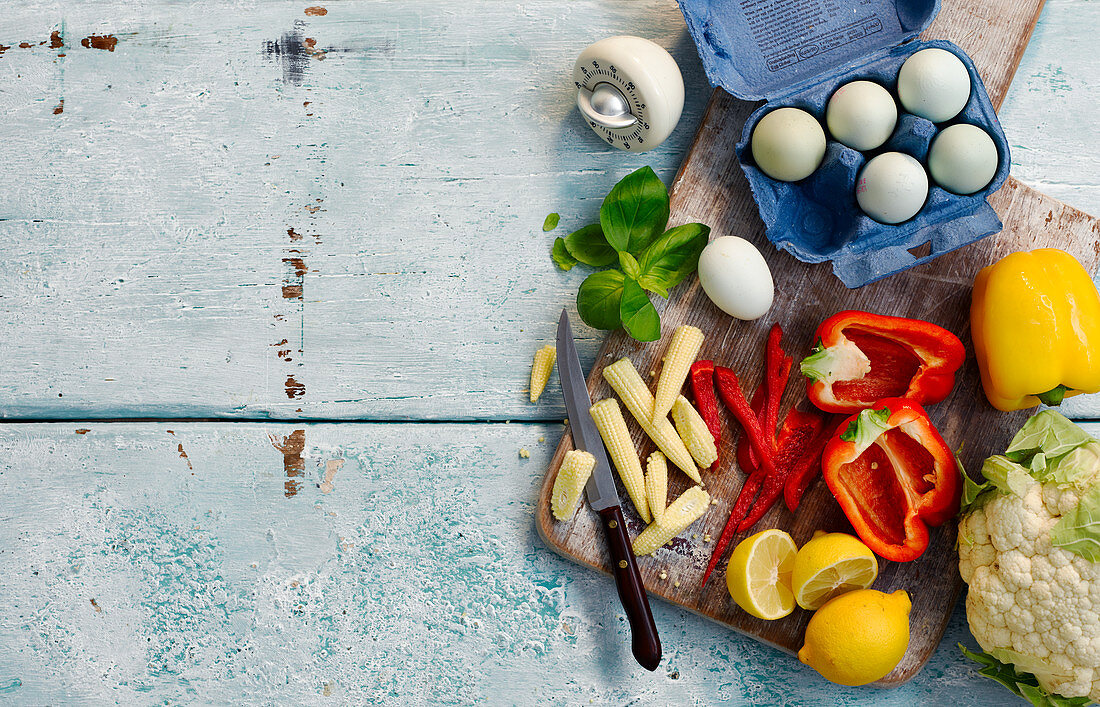 Vegetable still life with baby corncobs, eggs and lemons