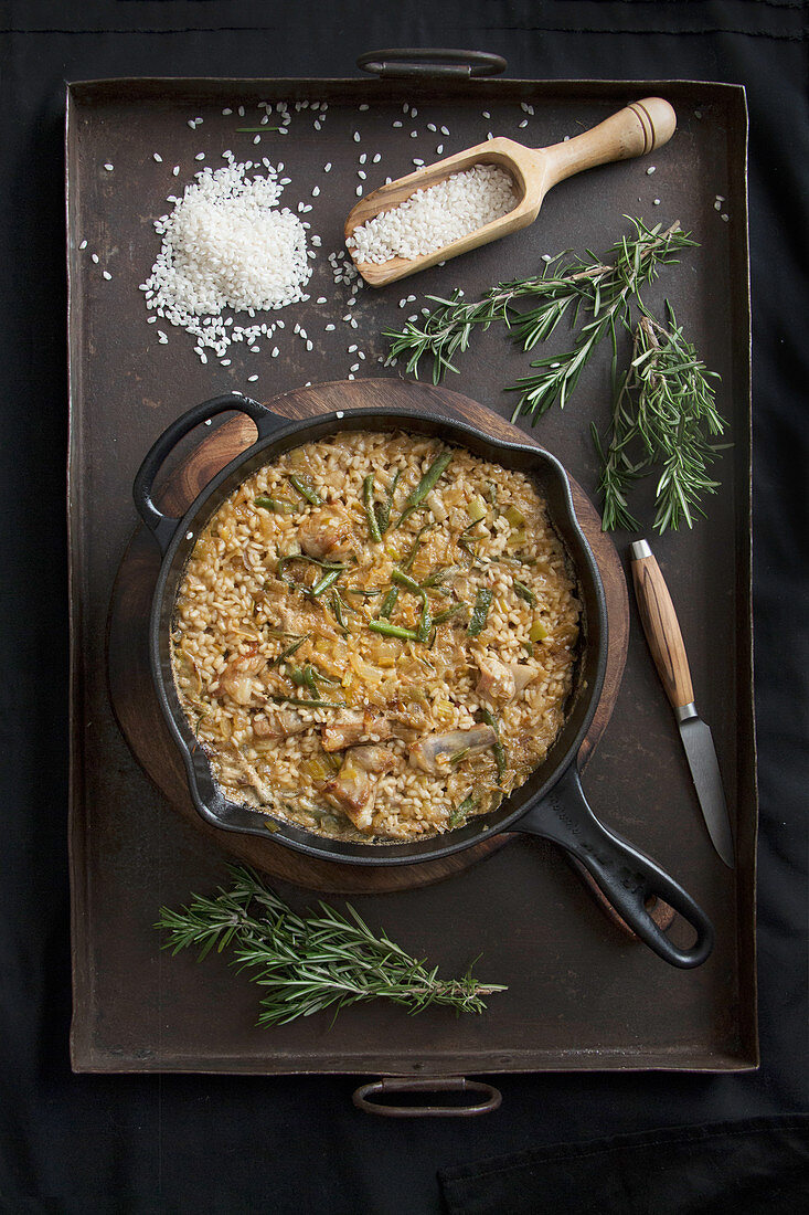 Risotto with spices and rosemary on a pan