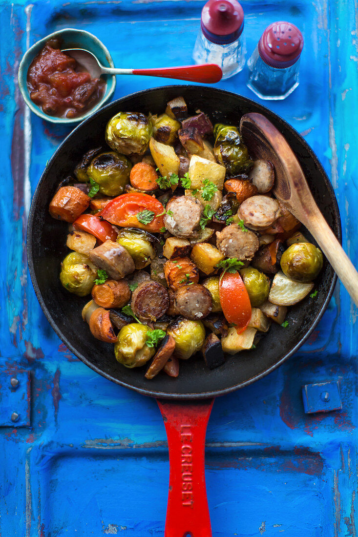 Sausages with brussels sprouts, sweet potatoes and tomatoes