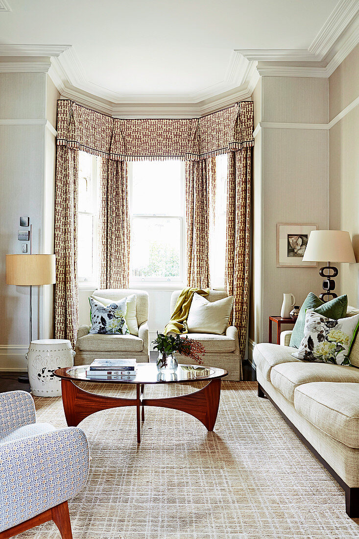 Elegant living room with upholstered furniture and bay area