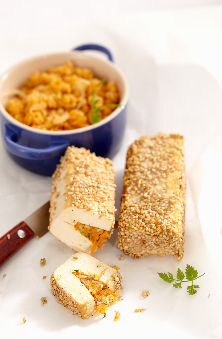 Baked tofu slices in a sesame coating with lentils