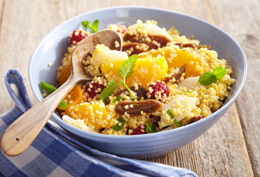 Fruity millet salad with orange, fig, pear, physalis and raspberries