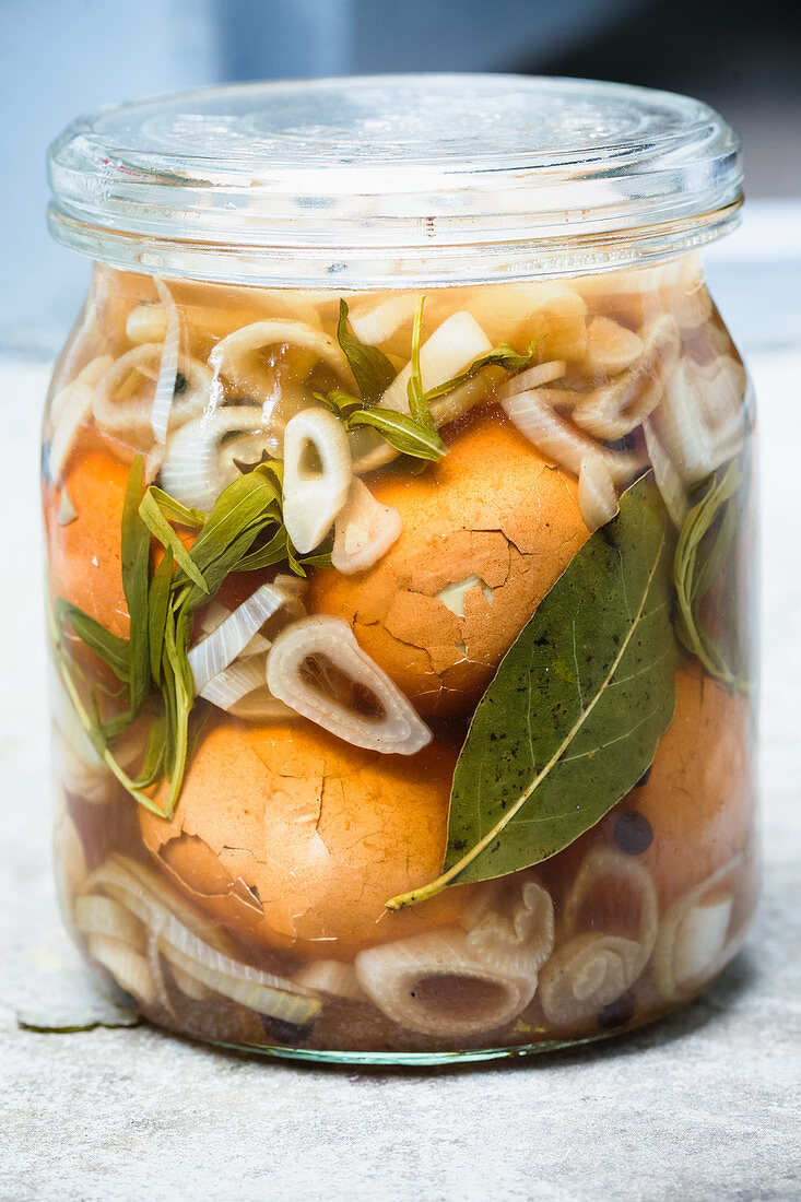 Pickled eggs with shallots in a jar (close up)