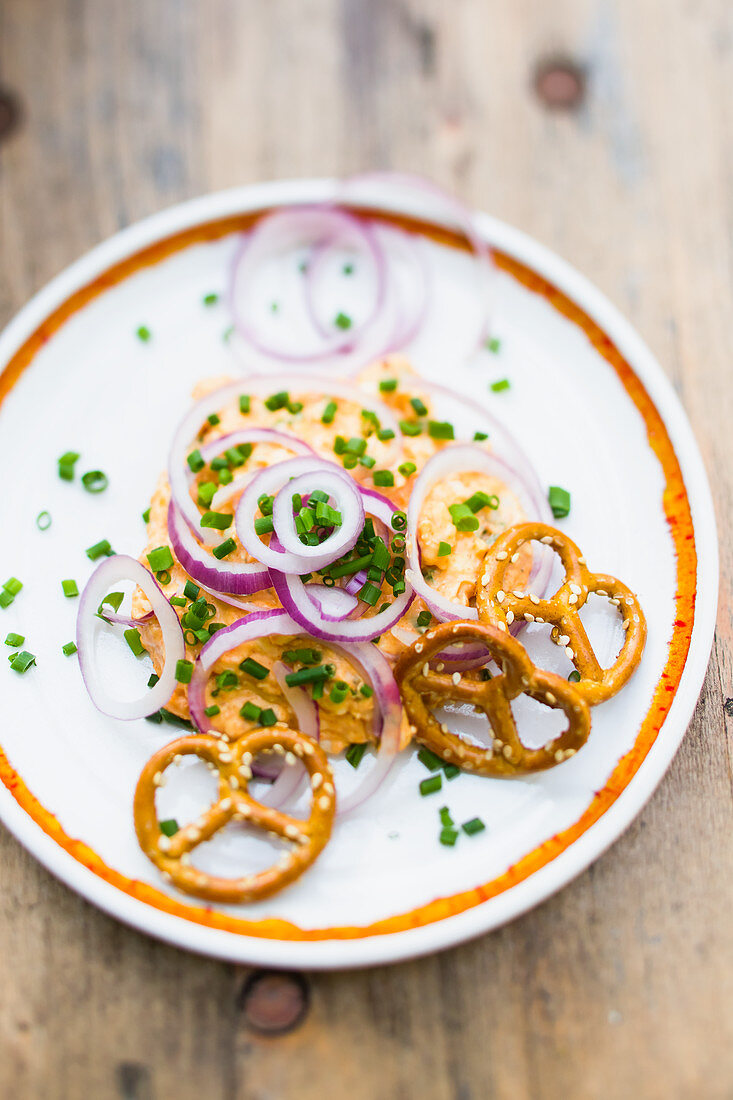 Obatzda with red onion rings and salt pretzels