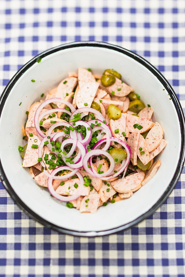 Sausage salad with Regensburg sausages, gherkins, and onions