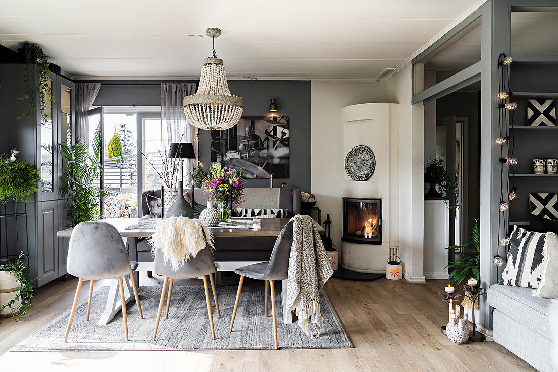 Fireplace in dining area of open-plan interior in shades of grey