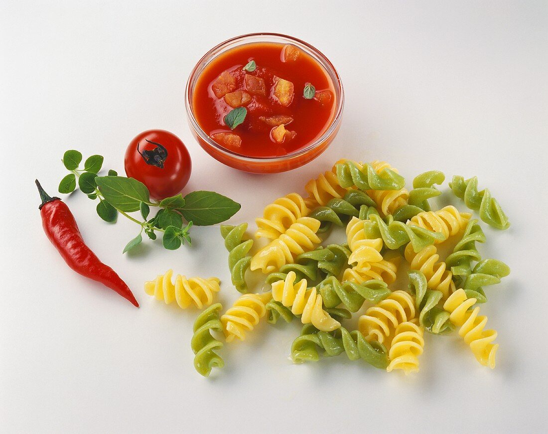Fusilli, bowl of tomato and pepper sauce and ingredients