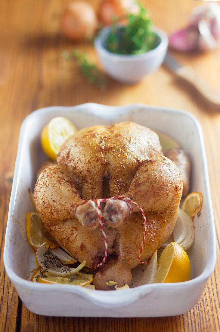 Fried chicken with lemon and onions in a roasting pan