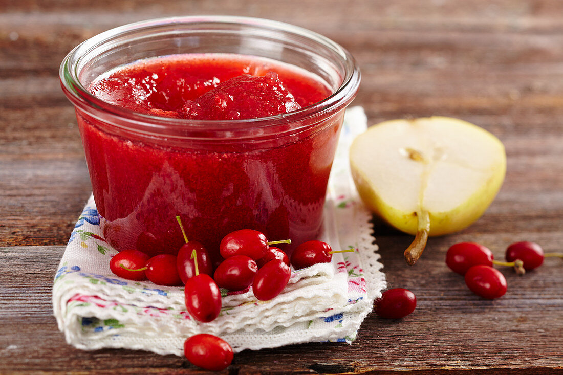 Homemade cornelian cherry and pear jam in a mason jar