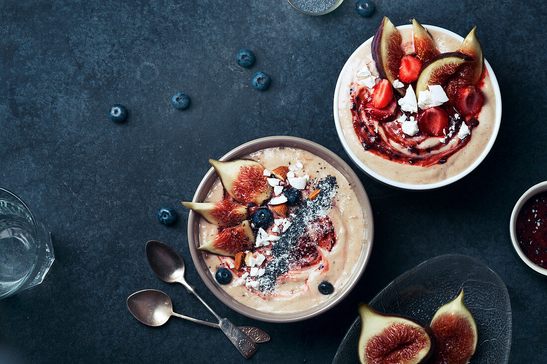 Blueberry banana smoothie bowl with figs and almond milk bowl with strawberries