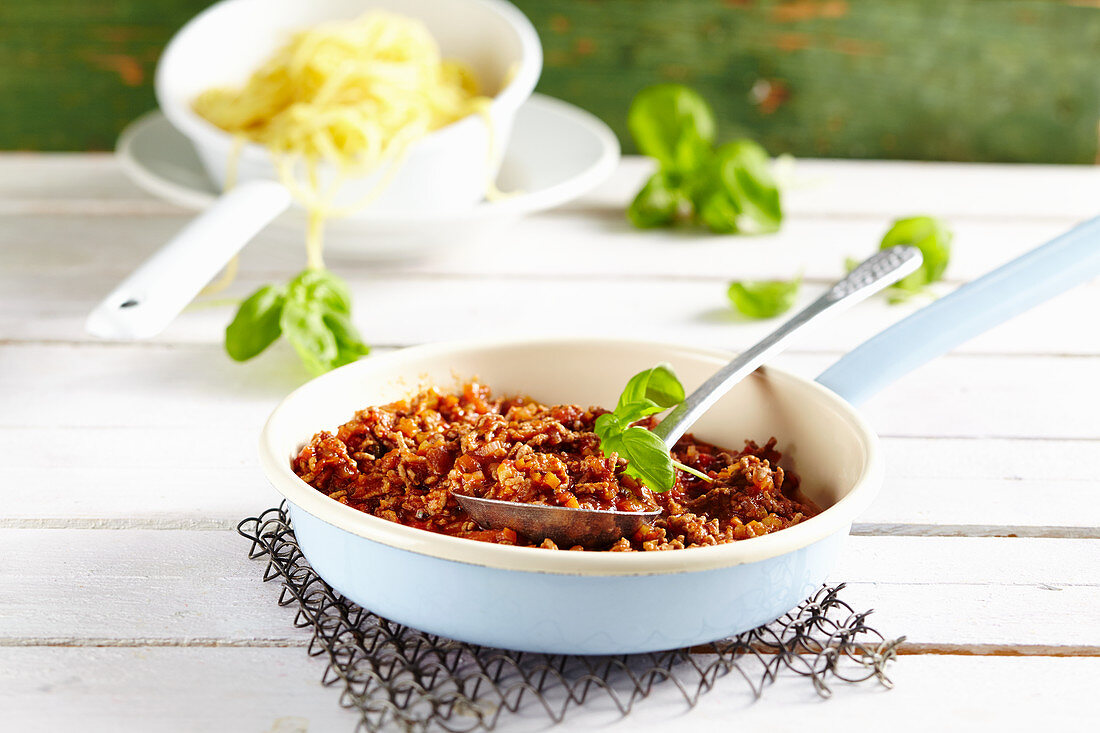 Classic bolognese sauce in a pan with a spoon