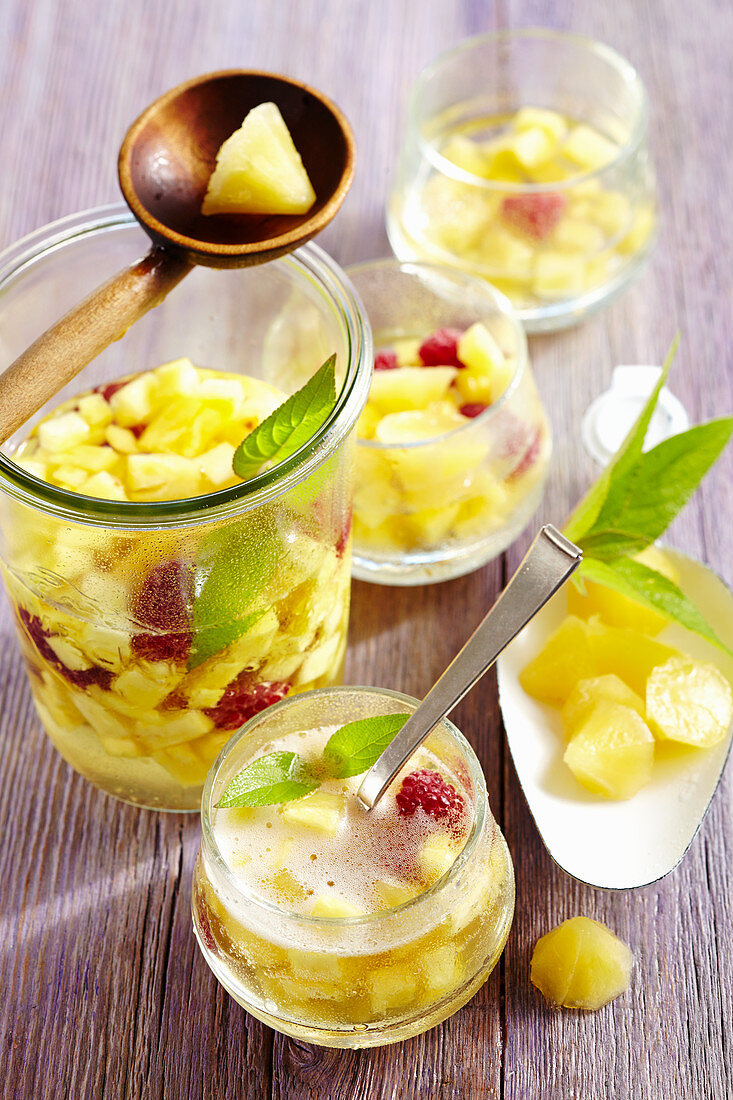 Pineapple punch with raspberries and pineapple ice cubes